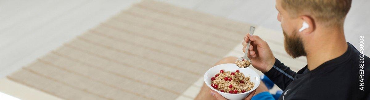 Hombre como de un plato con granola.